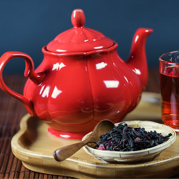 red tea in red teapot image